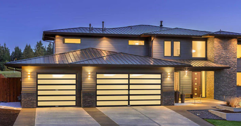 Modern house with illuminated glass garage doors